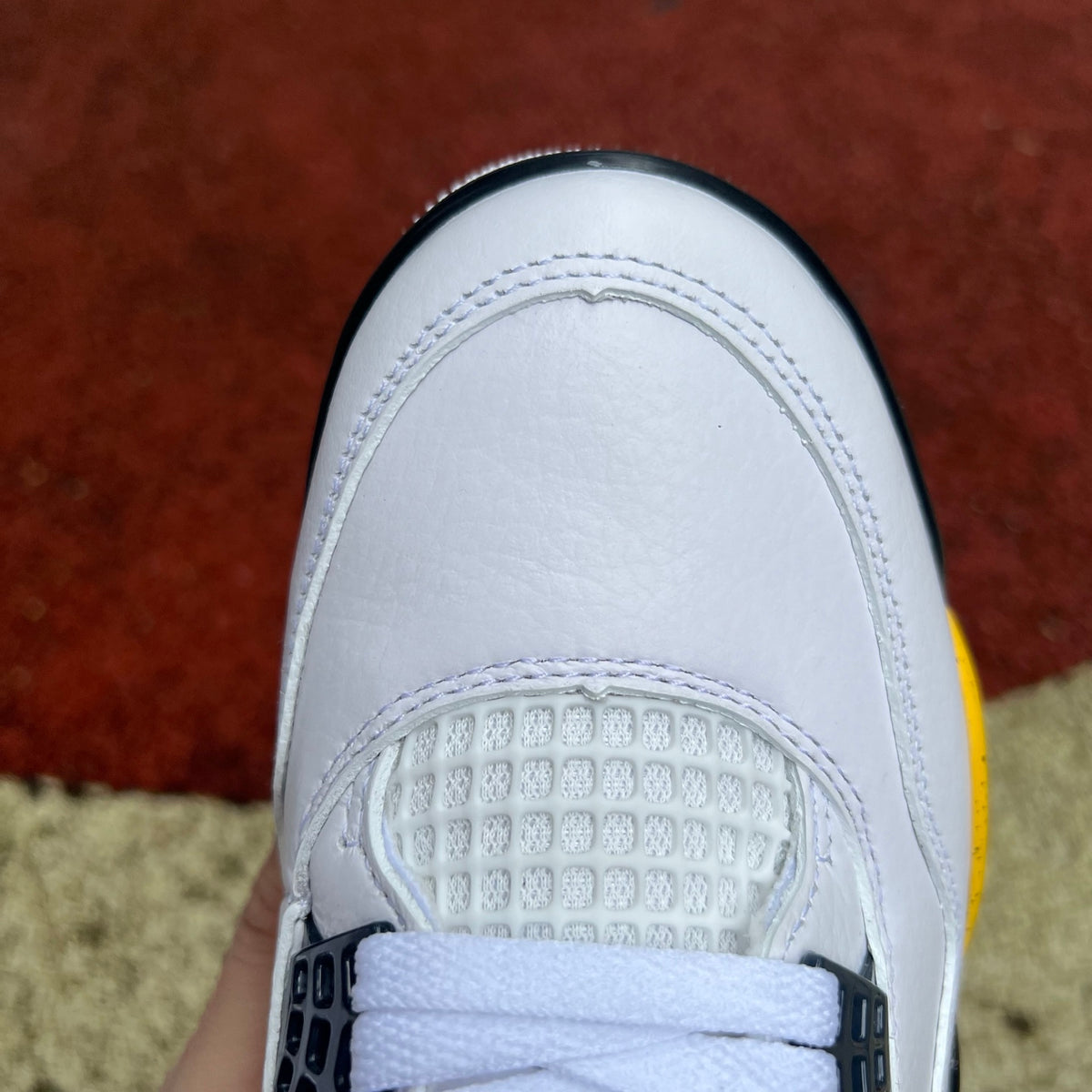 Nike x Jordan Air Jordan 4 Retro Rare Air Tour Yellow sneakers, front view showcasing yellow and black design details