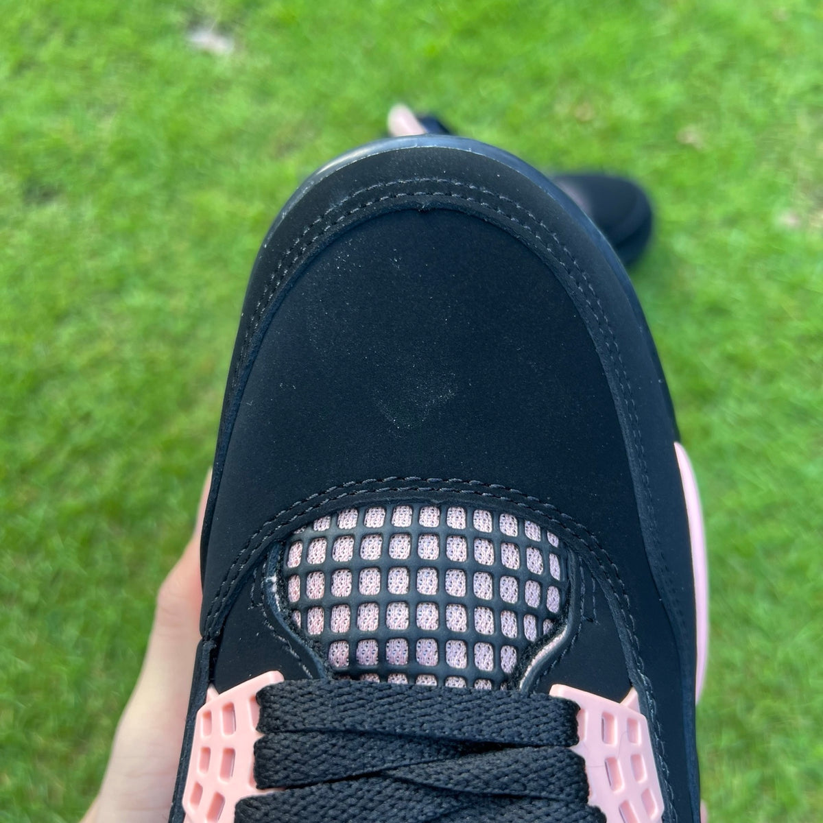 Nike Jordan Air Jordan 4 Retro Rust Pink Thunder women's sneakers showcasing pink and gray colorway with textured material details.