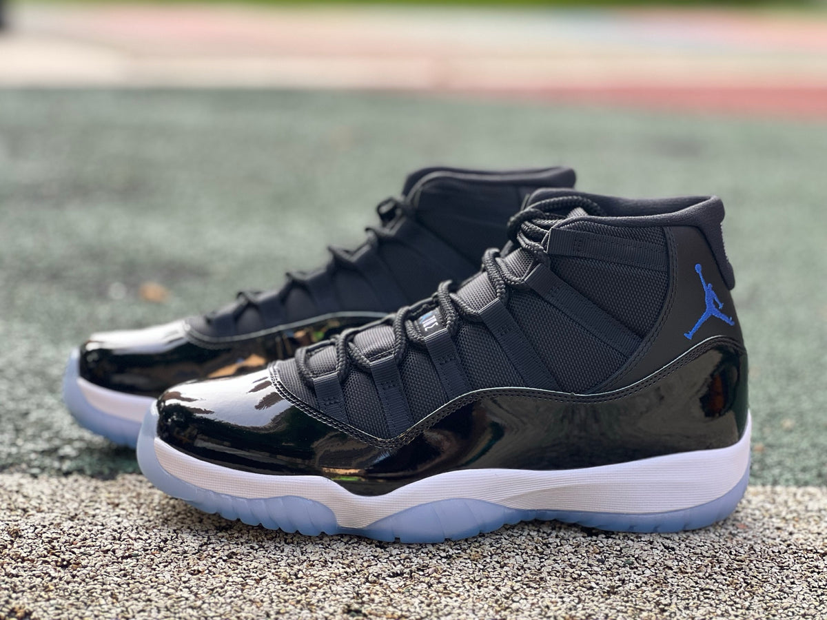Nike Air Jordan 11 Retro Space Jam sneakers in black and blue with patent leather and Jumpman logo.