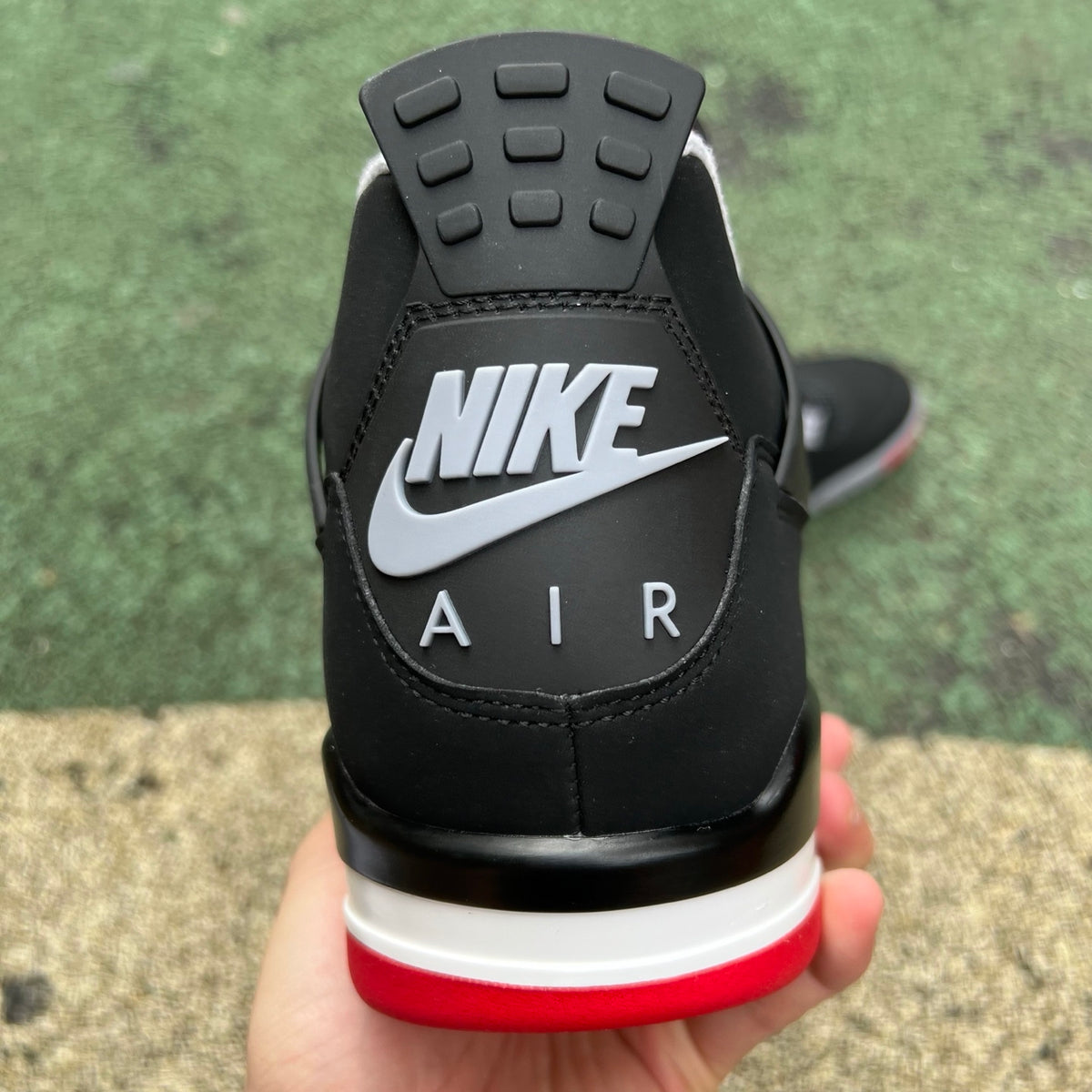 Nike Air Jordan 4 Retro OG Bred sneakers in black and red with white accents, featuring classic design and signature details.