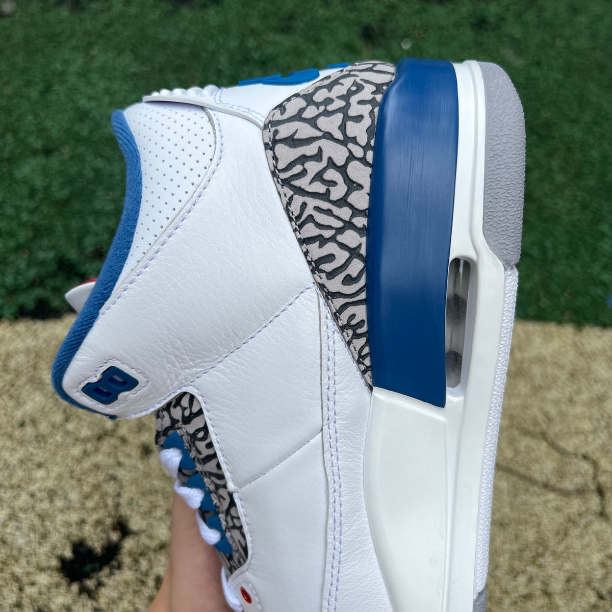 Nike Air Jordan 3 Retro True Blue sneakers featuring white, blue, and grey leather with Nike and Jordan branding details.
