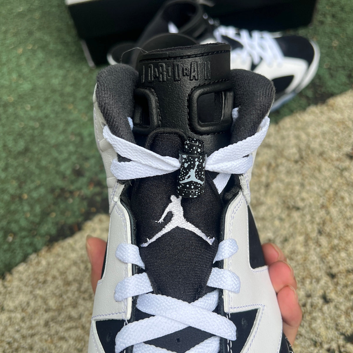 Nike Air Jordan 6 Retro Oreo sneakers in black and white with a sleek design and visible branding, showcasing the classic basketball shoe style.
