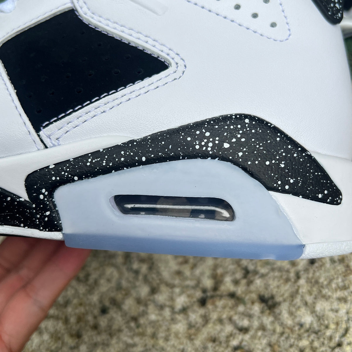 Nike Air Jordan 6 Retro Oreo sneakers in black and white with red accents, featuring a sleek design and classic Jordan style.