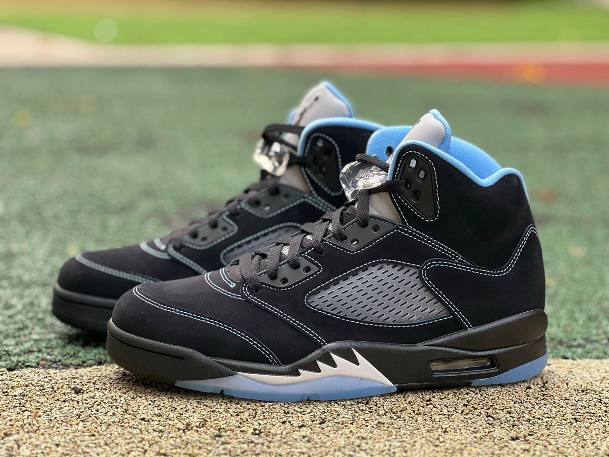 Nike Air Jordan 5 Retro sneakers in black and university blue with a sleek design and visible midsole details.