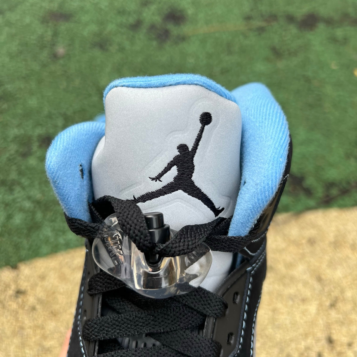 Nike Air Jordan 5 Retro sneakers in black and university blue, featuring a sleek design and signature details.