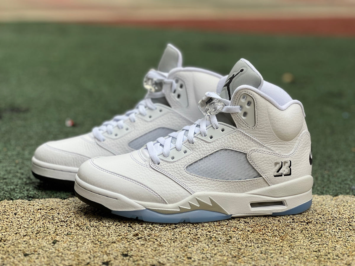 Nike Air Jordan 5 Retro White Metallic sneakers with white and metallic silver details, high-top design and visible air cushioning.