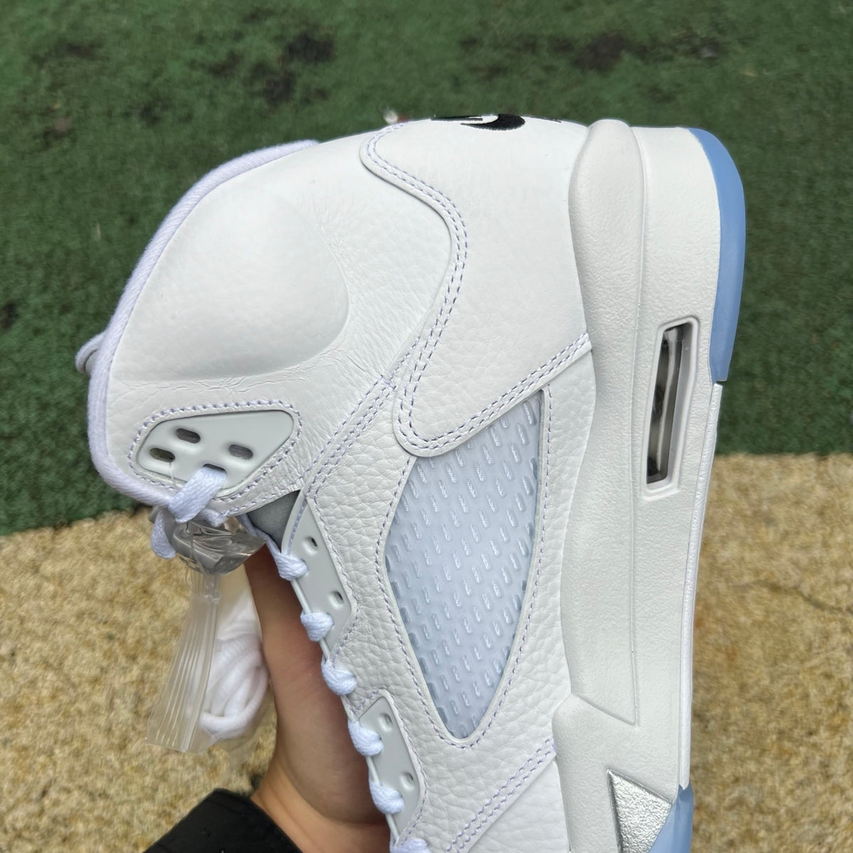 Nike Air Jordan 5 Retro White Metallic sneakers, close-up of the classic design with white and metallic accents.