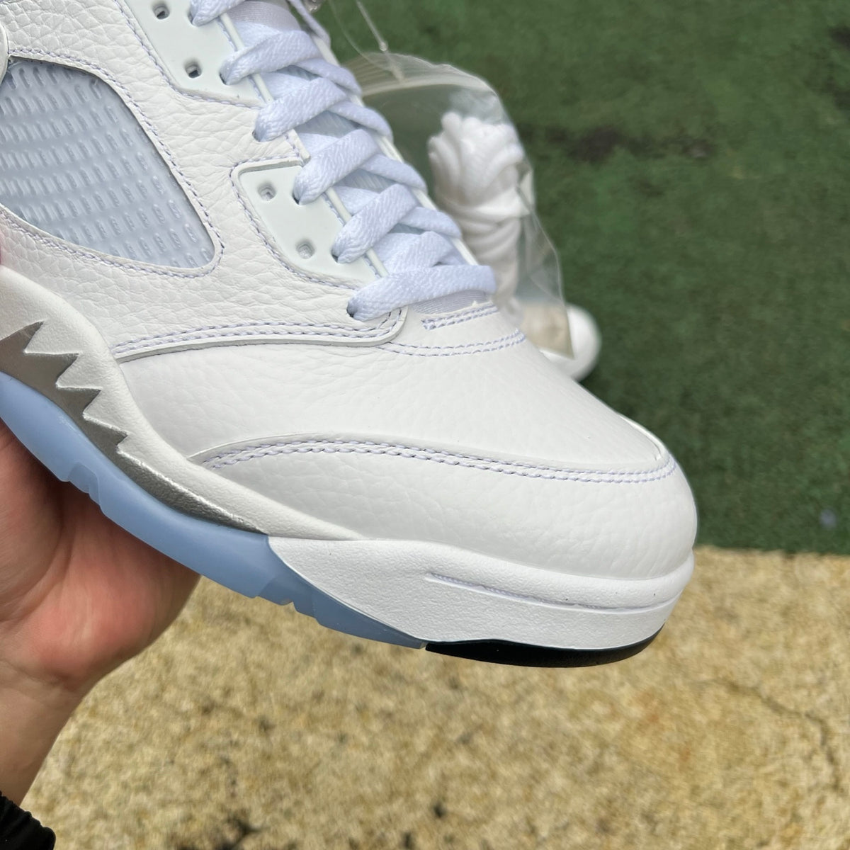 Nike Air Jordan 5 Retro White Metallic sneakers on a plain background, showcasing the classic design and premium materials.