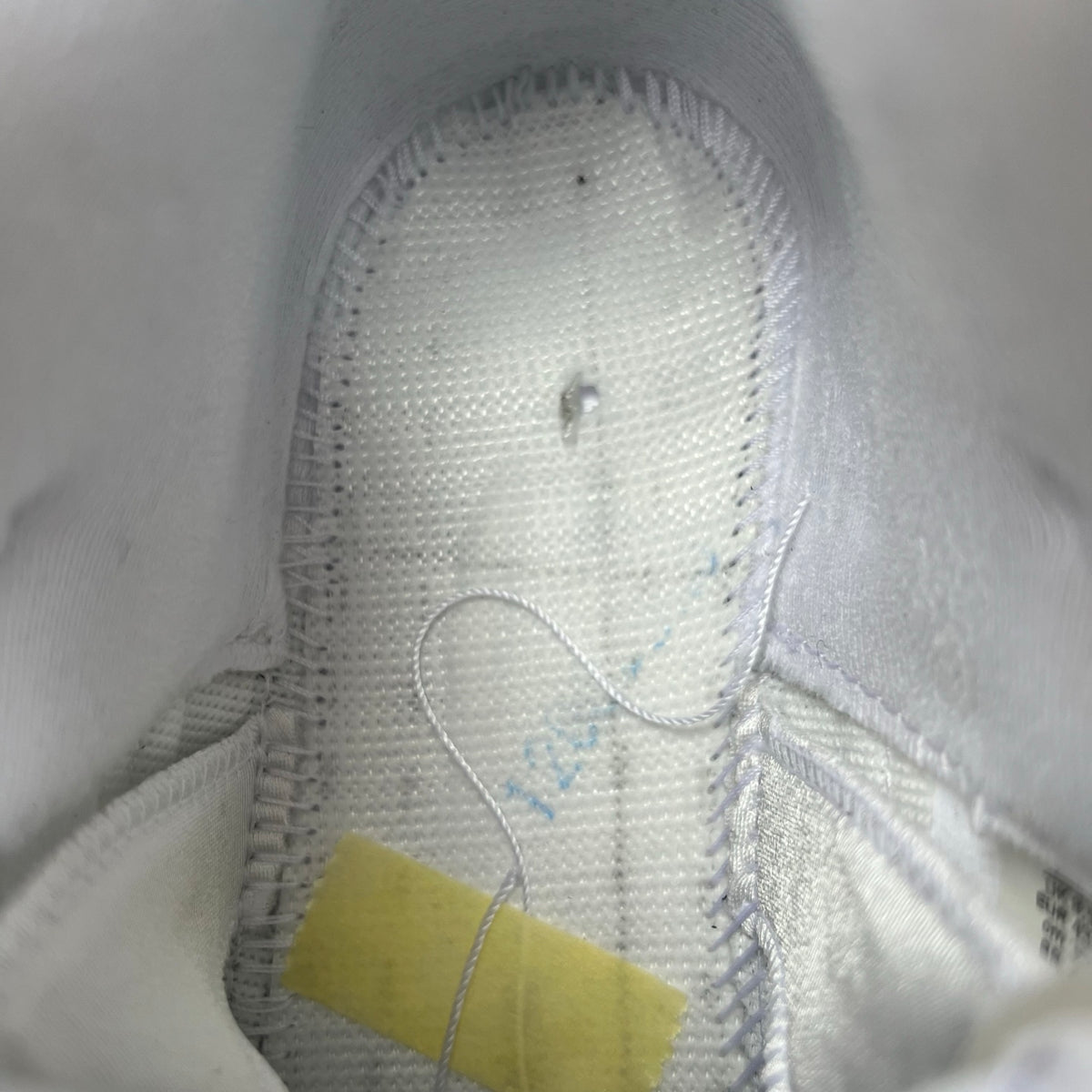 Close-up of Nike Air Jordan 5 Retro White Metallic sneakers showing the white and metallic silver design details