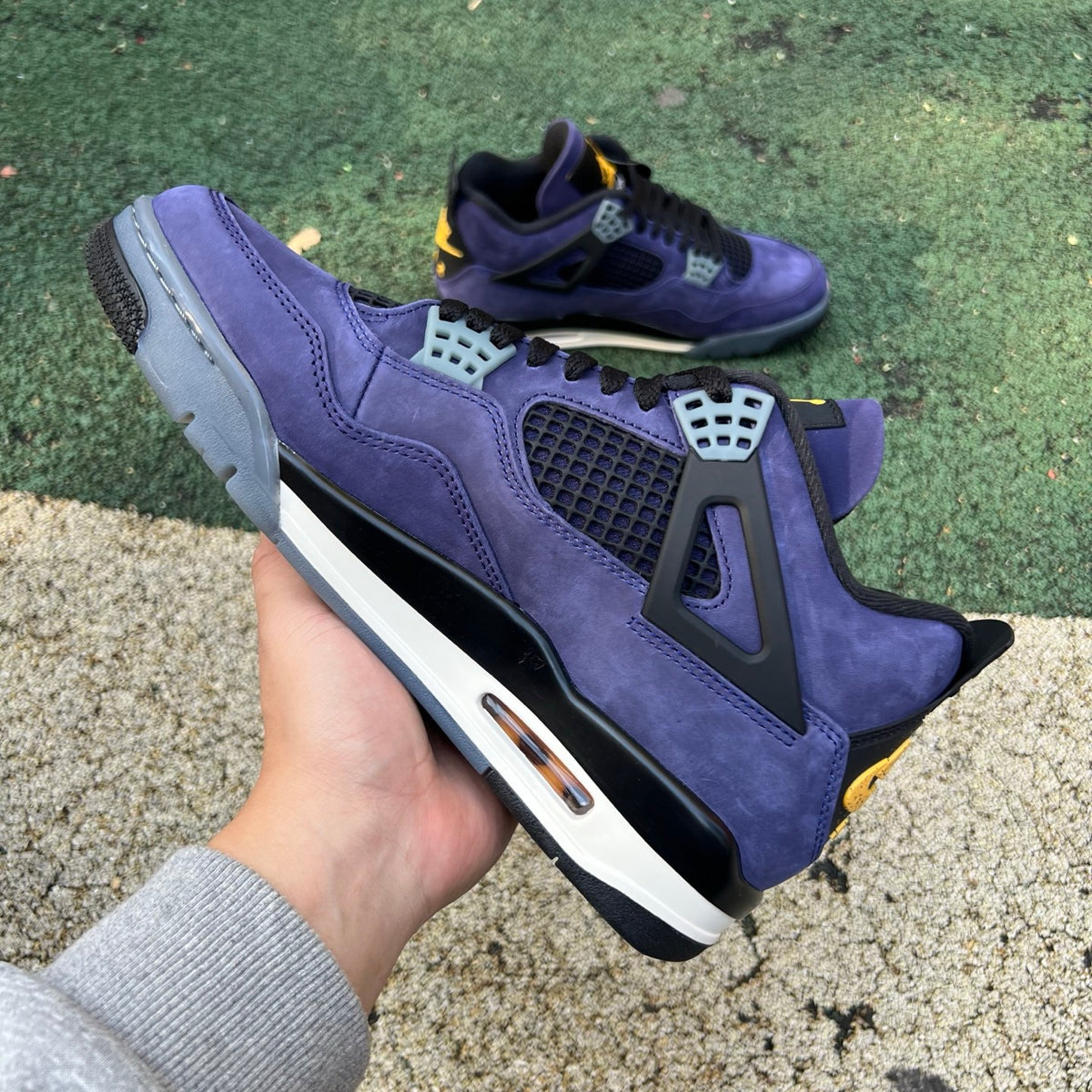 Nike Air Jordan 4 Retro Lakers sneakers in purple and gold, featuring classic design and Nike x Jordan branding.