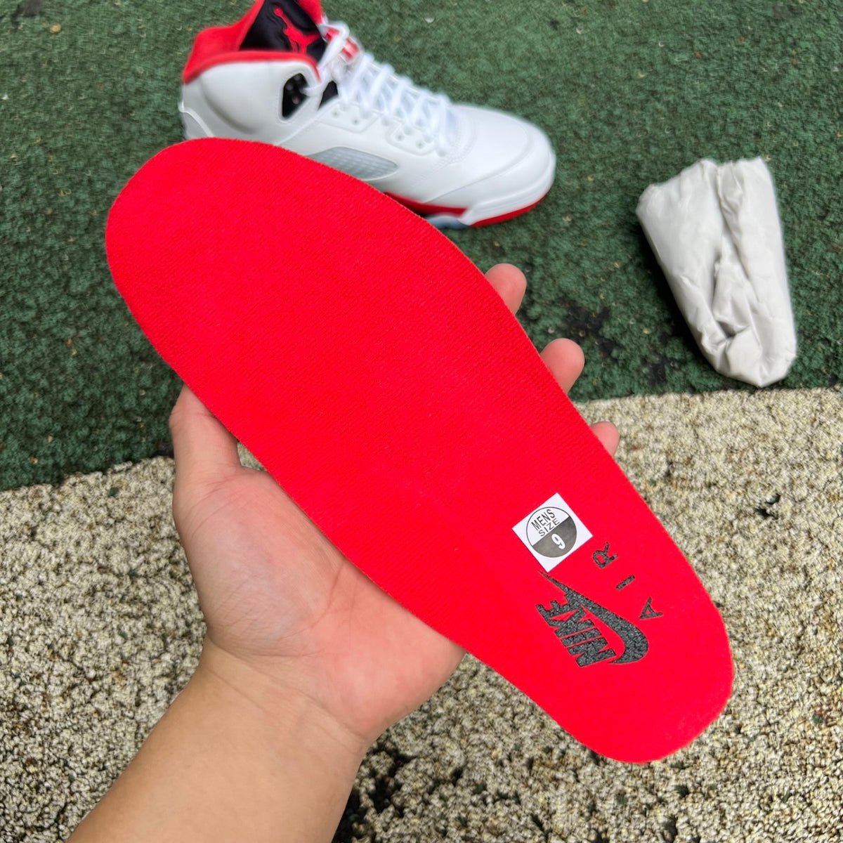 Nike Air Jordan 5 Retro Fire Red and Black sneakers with tongue detail, classic design, and premium materials.