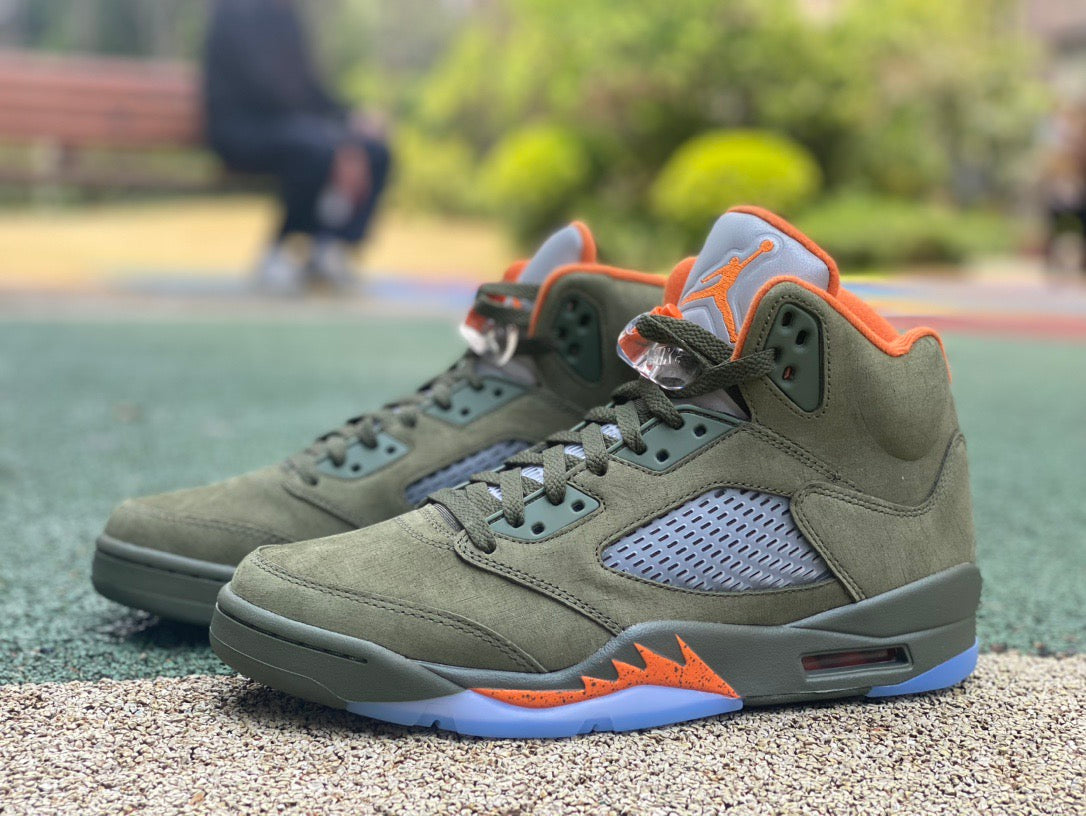 Nike Air Jordan 5 Retro Olive sneakers in a close-up view, showcasing the olive green and black colorway with textured details.