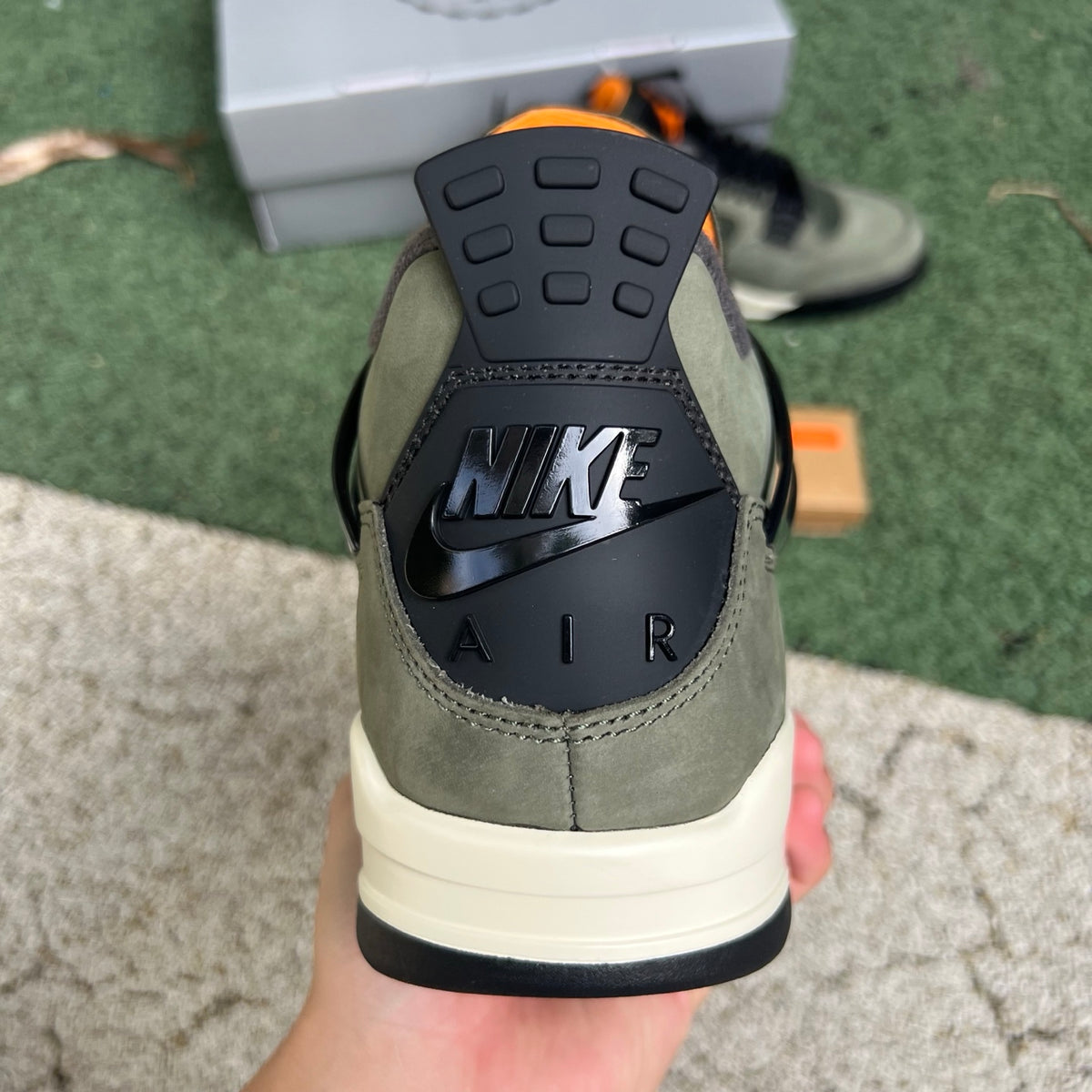 Nike Air Jordan 4 Retro OG SP Undefeated sneakers in black and white with signature design details, logo, and classic style.