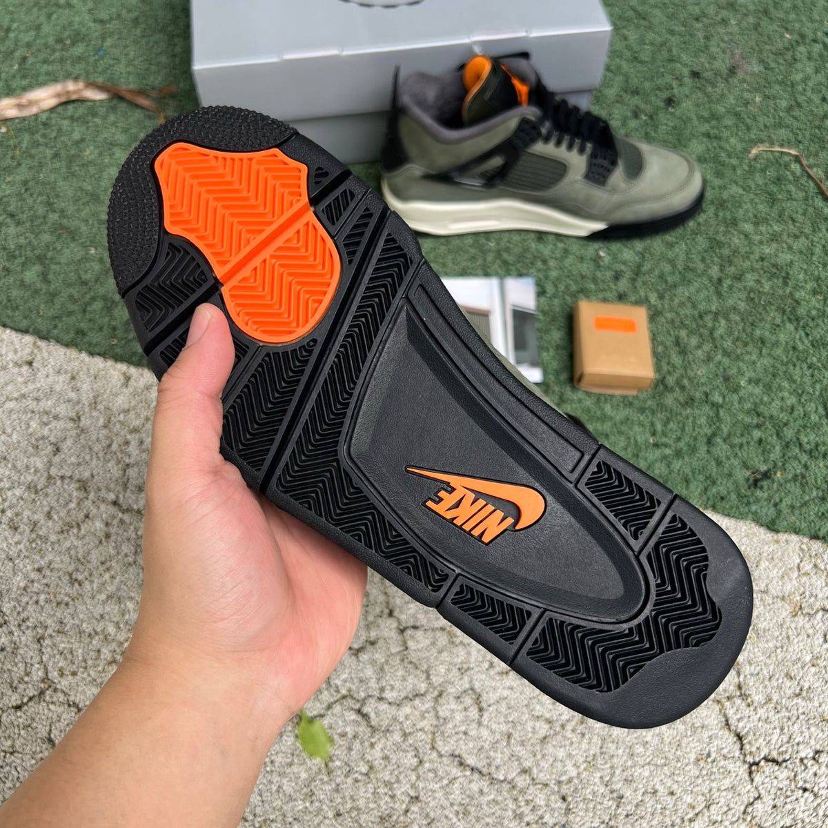 Nike Air Jordan 4 Retro OG SP Undefeated sneakers in black and white with signature details, showcasing classic basketball shoe design.