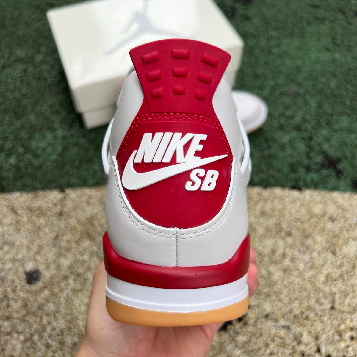 Nike Air Jordan 4 Retro SB Varsity Red sneakers, side view showing red and black colorway with signature design details.