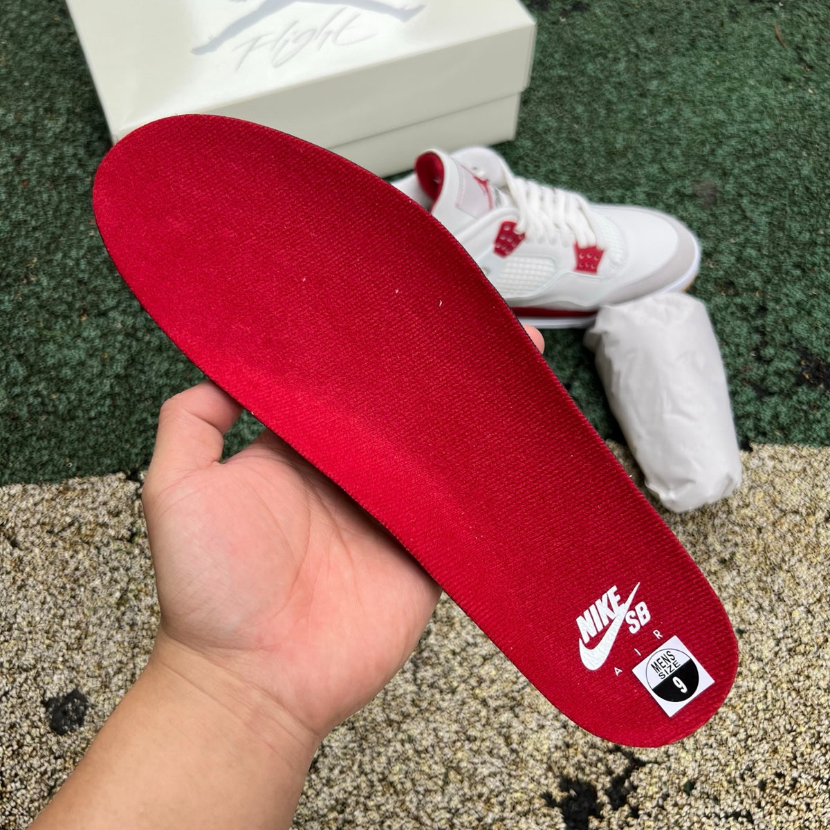 Nike Air Jordan 4 Retro SB Varsity Red sneakers featuring red and black colorway, white midsole, and classic Jordan branding