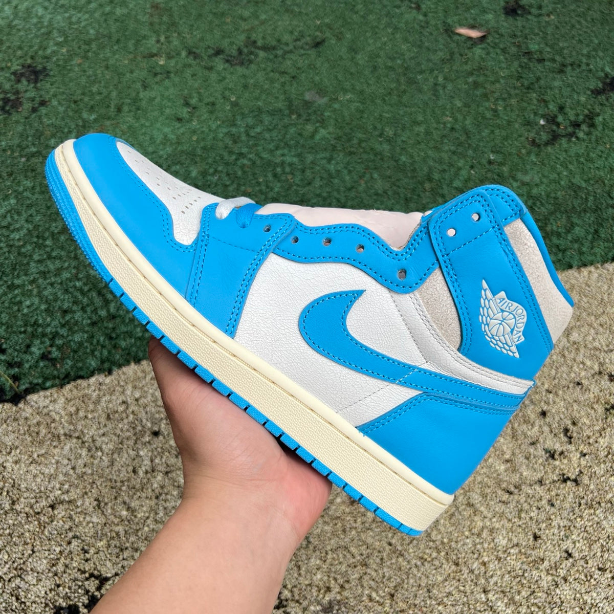 Nike Air Jordan 1 Retro High OG UNC Reimagined sneakers, featuring classic design and blue and white colorway.