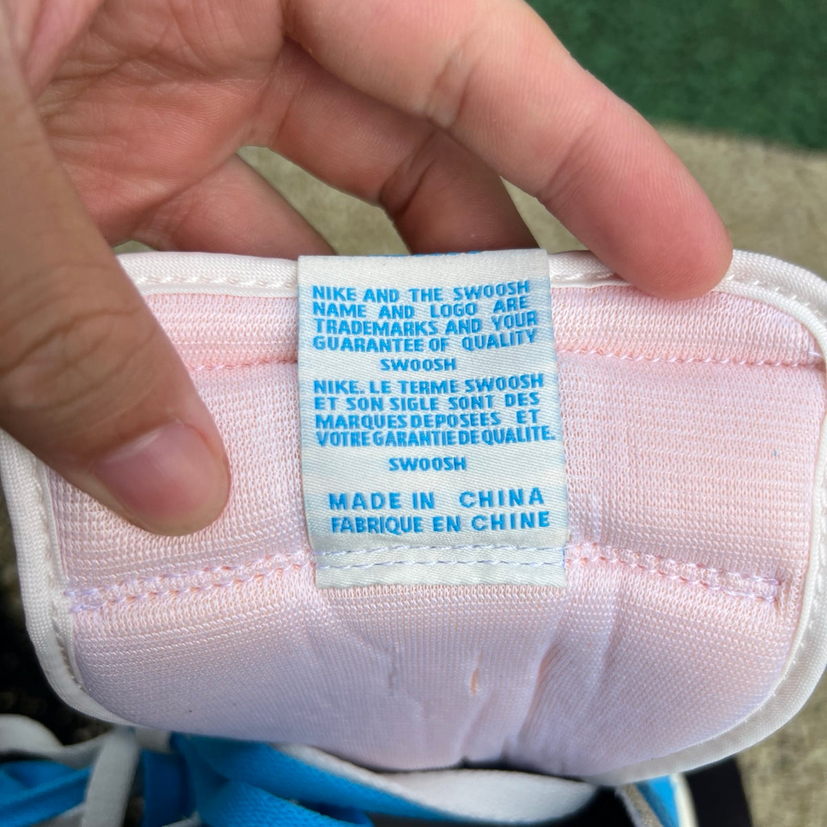 Nike Air Jordan 1 Retro High OG UNC Reimagined sneakers in white and blue leather, featuring Nike and Jordan branding.