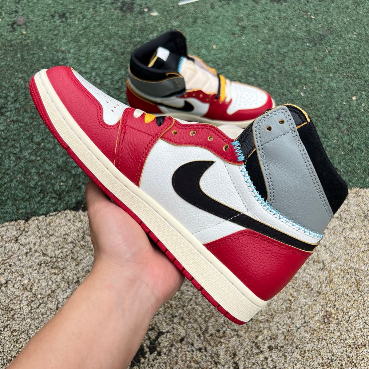 Nike Air Jordan 1 Retro High OG SP Union LA Chicago Shadow sneakers, featuring black, gray, and red colorway, on a plain background.