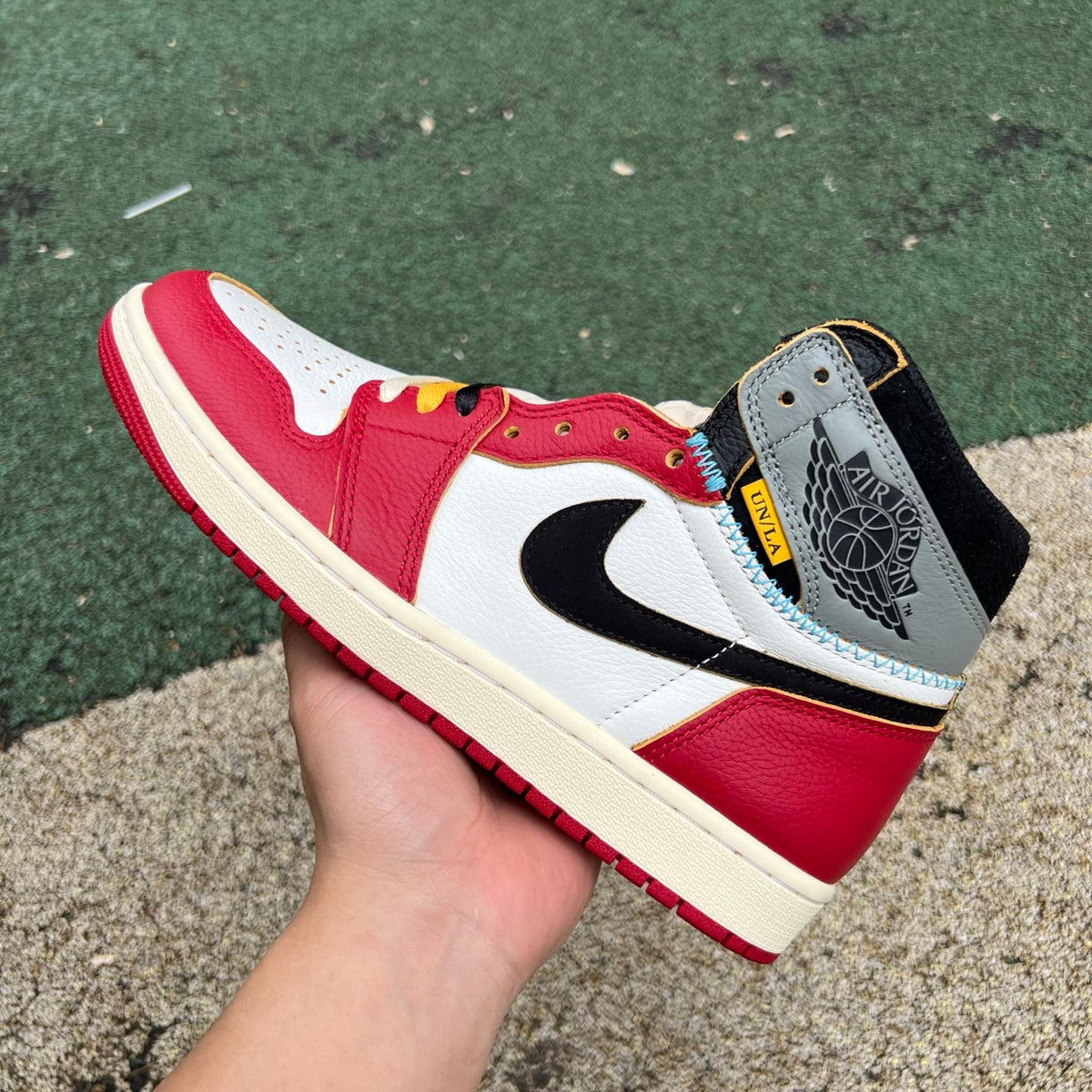 Nike Air Jordan 1 Retro High OG SP Union LA Chicago Shadow sneakers, featuring black and gray leather design with Nike x Jordan branding.