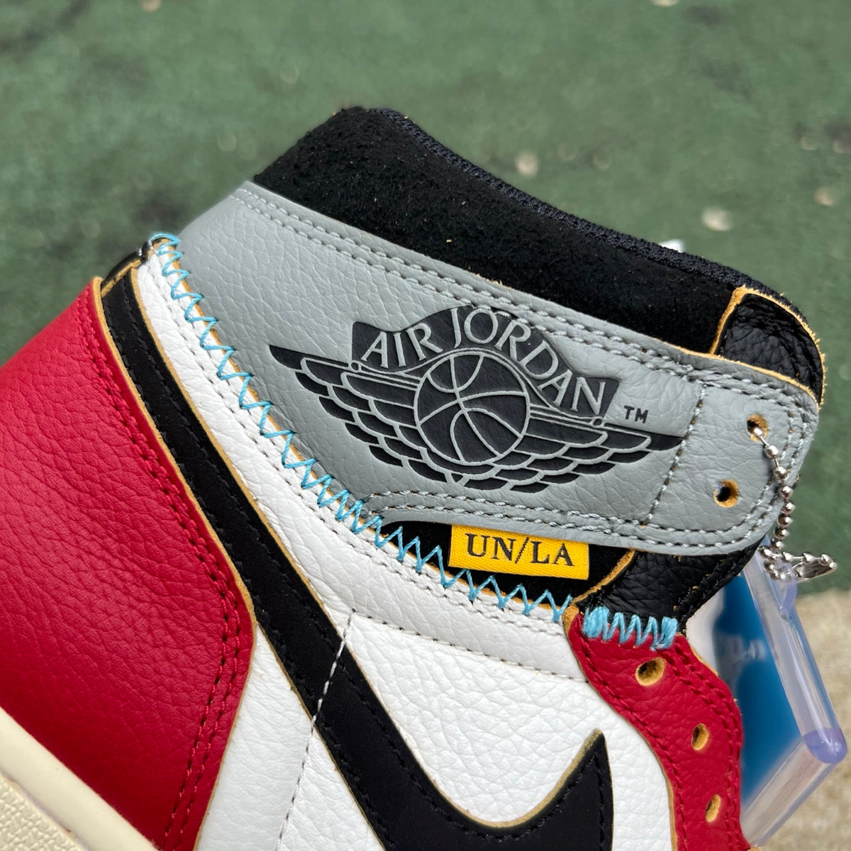 Nike Air Jordan 1 Retro High OG SP Union LA Chicago Shadow sneakers featuring black and gray leather with red accents.