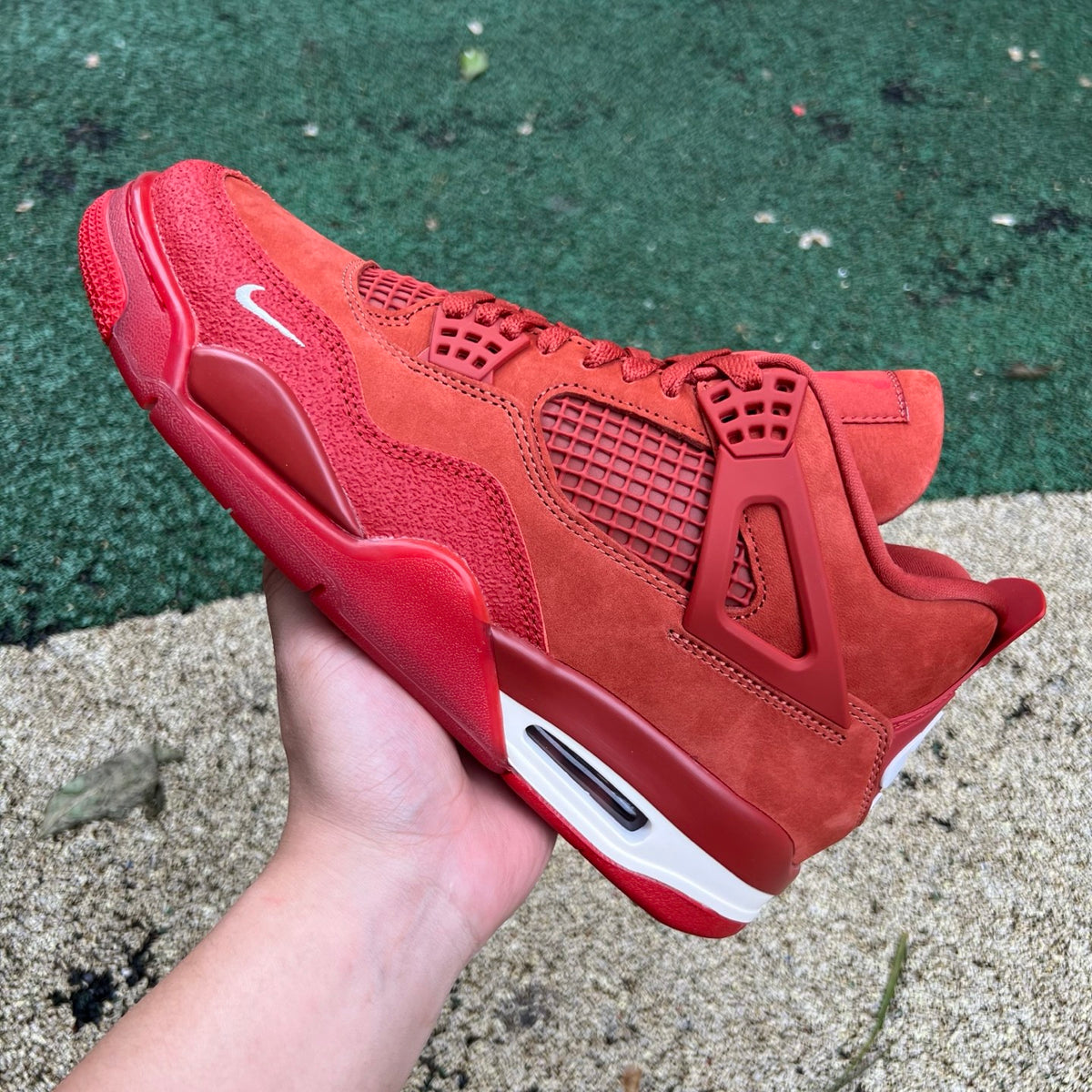 Nike Air Jordan 4 Retro OG SP Nigel Sylvester Brick by Brick sneakers in black and red, featuring signature Nike x Jordan branding.