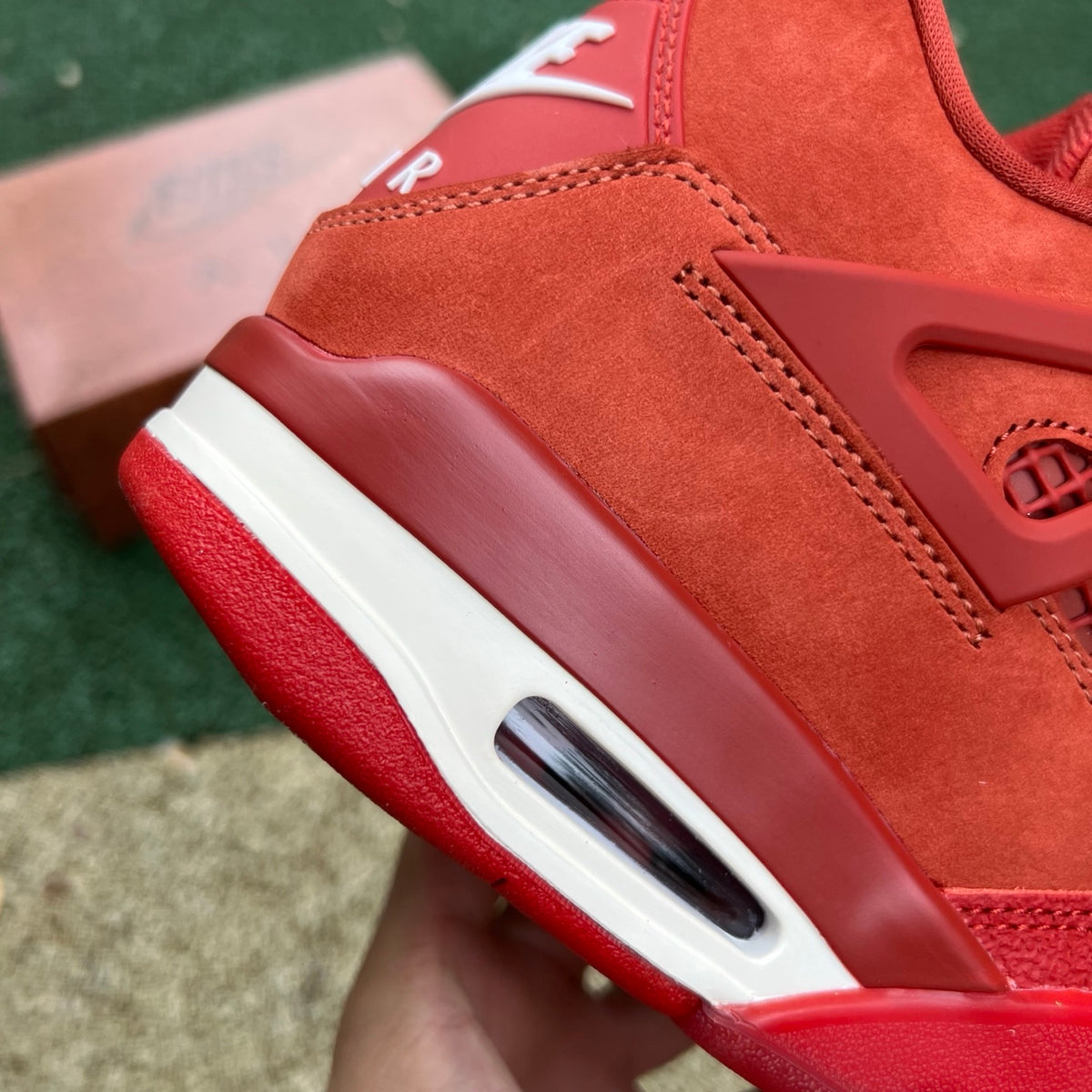 Nike Air Jordan 4 Retro OG SP Nigel Sylvester Brick by Brick sneaker in red and black with detailed design and signature branding.
