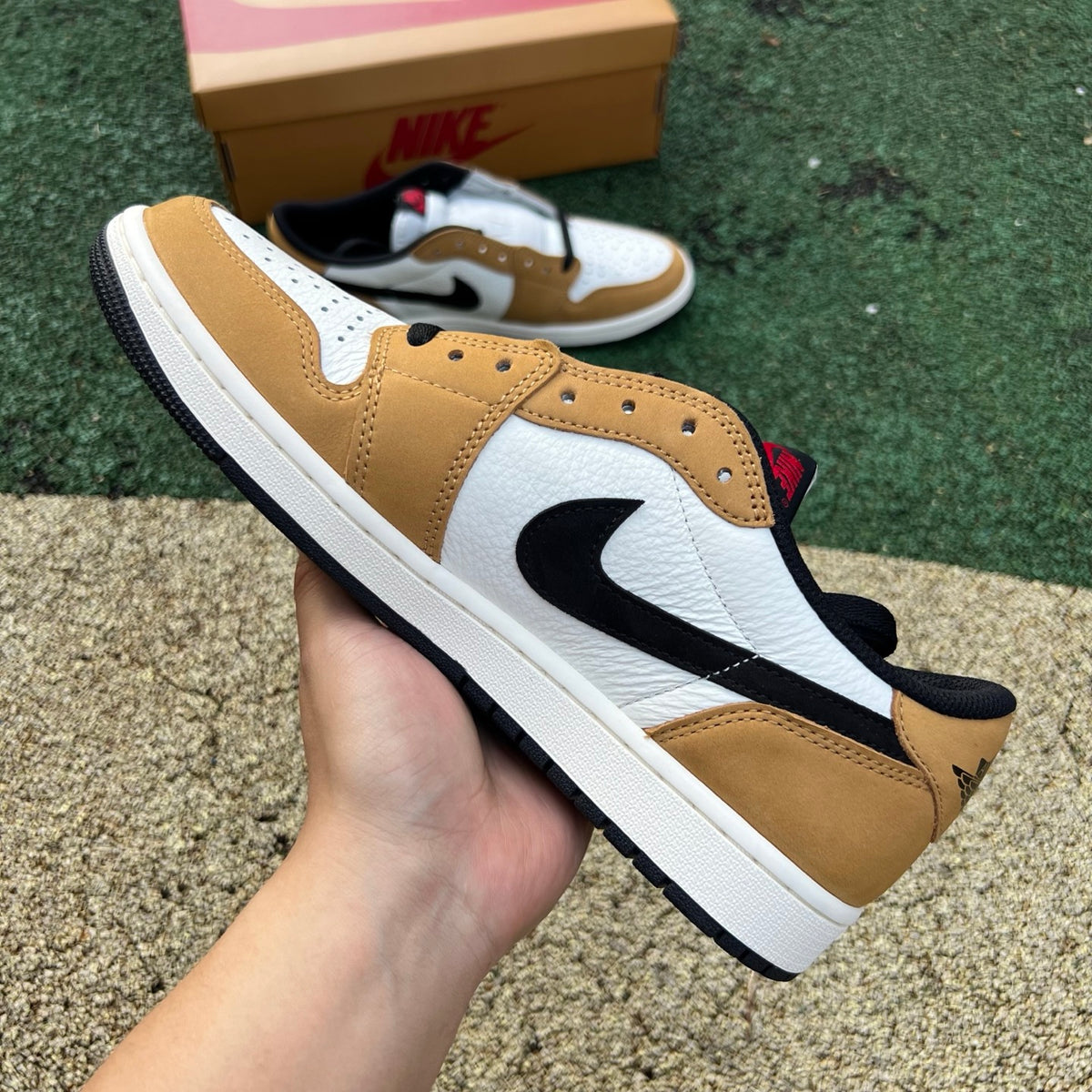 Nike Air Jordan 1 Low OG Rookie of the Year sneakers in white and black leather, featuring Nike and Jordan branding.