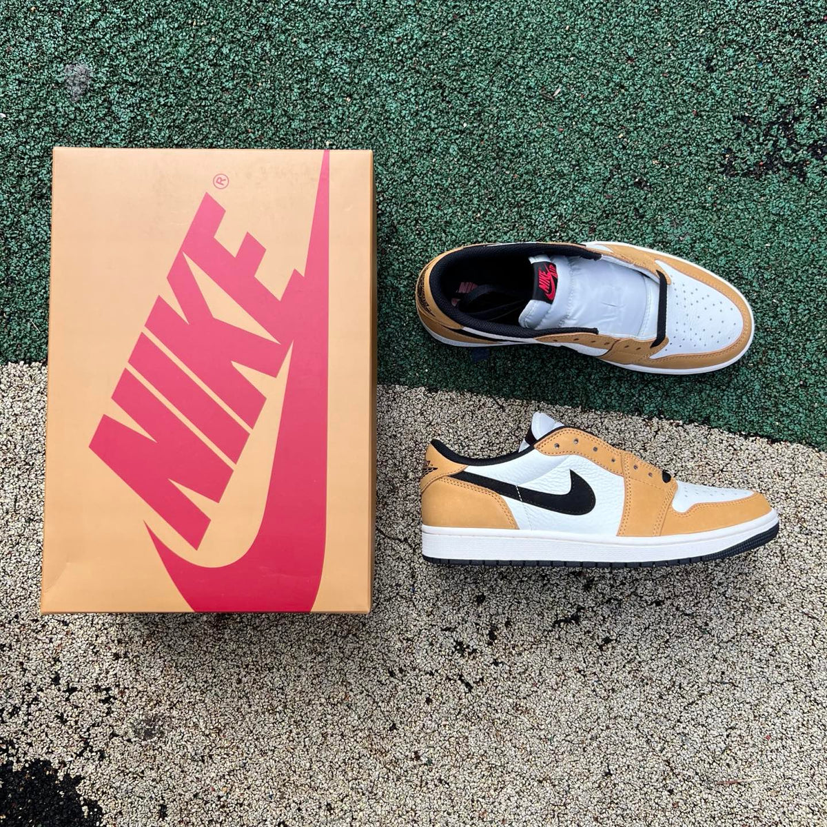 Nike Air Jordan 1 Low OG Rookie of the Year sneakers in white and black with Nike swoosh and Jordan branding.