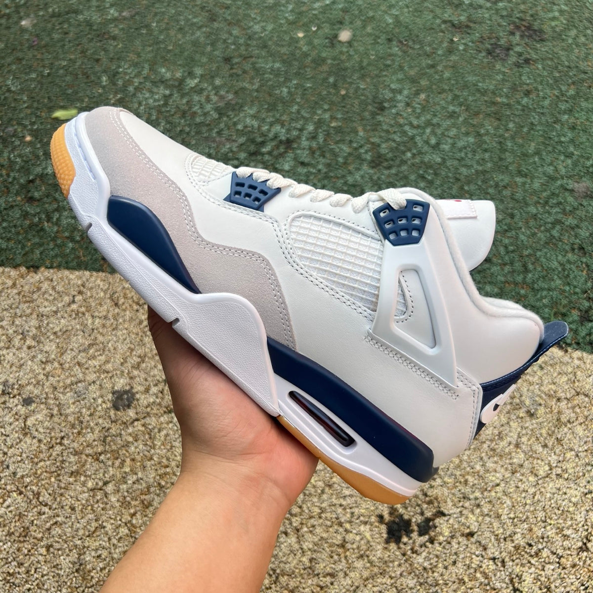 Nike Air Jordan 4 Retro SB sneakers in navy with white accents, showcasing classic design and signature branding.