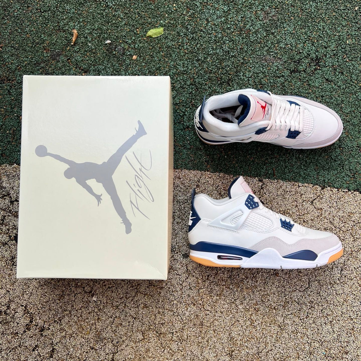 Nike Air Jordan 4 Retro SB sneakers in navy with white accents, featuring classic basketball shoe design and branding.