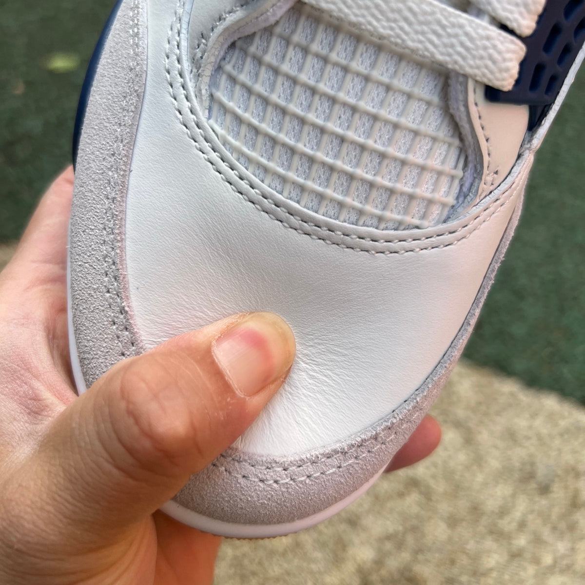 Nike Air Jordan 4 Retro SB sneakers in navy with white accents, featuring classic design and Nike x Jordan branding.