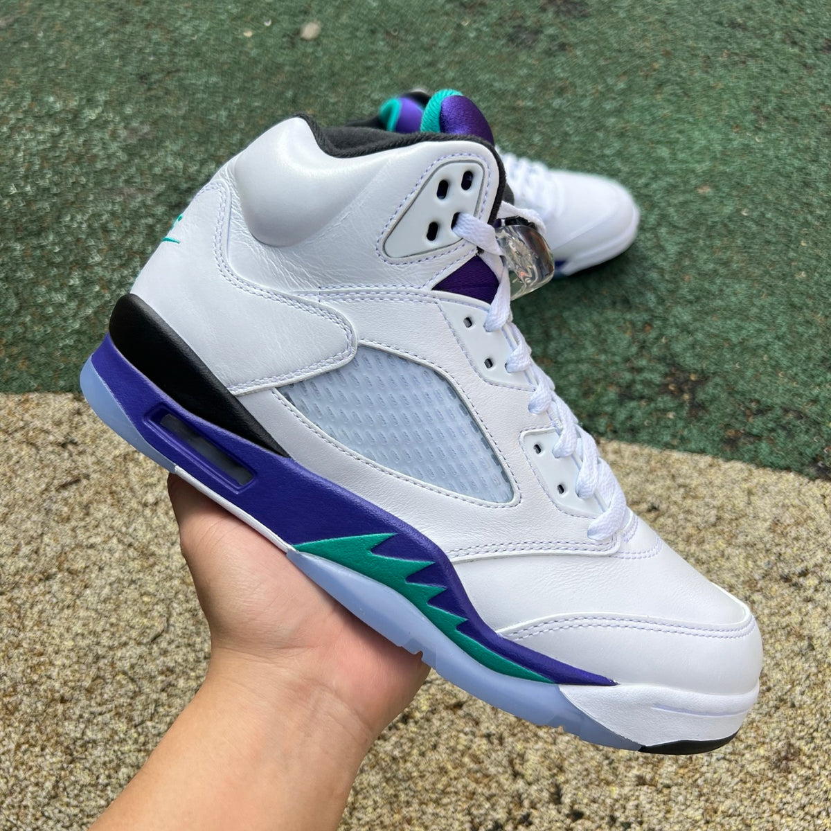 Nike Air Jordan 5 Retro Grape sneakers in white, purple, and teal colors, featuring the iconic design and Nike Jordan branding.