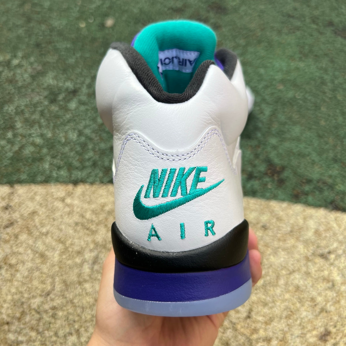 Nike Air Jordan 5 Retro Grape sneakers in white, purple, and black with detailed design and signature Jordan branding.