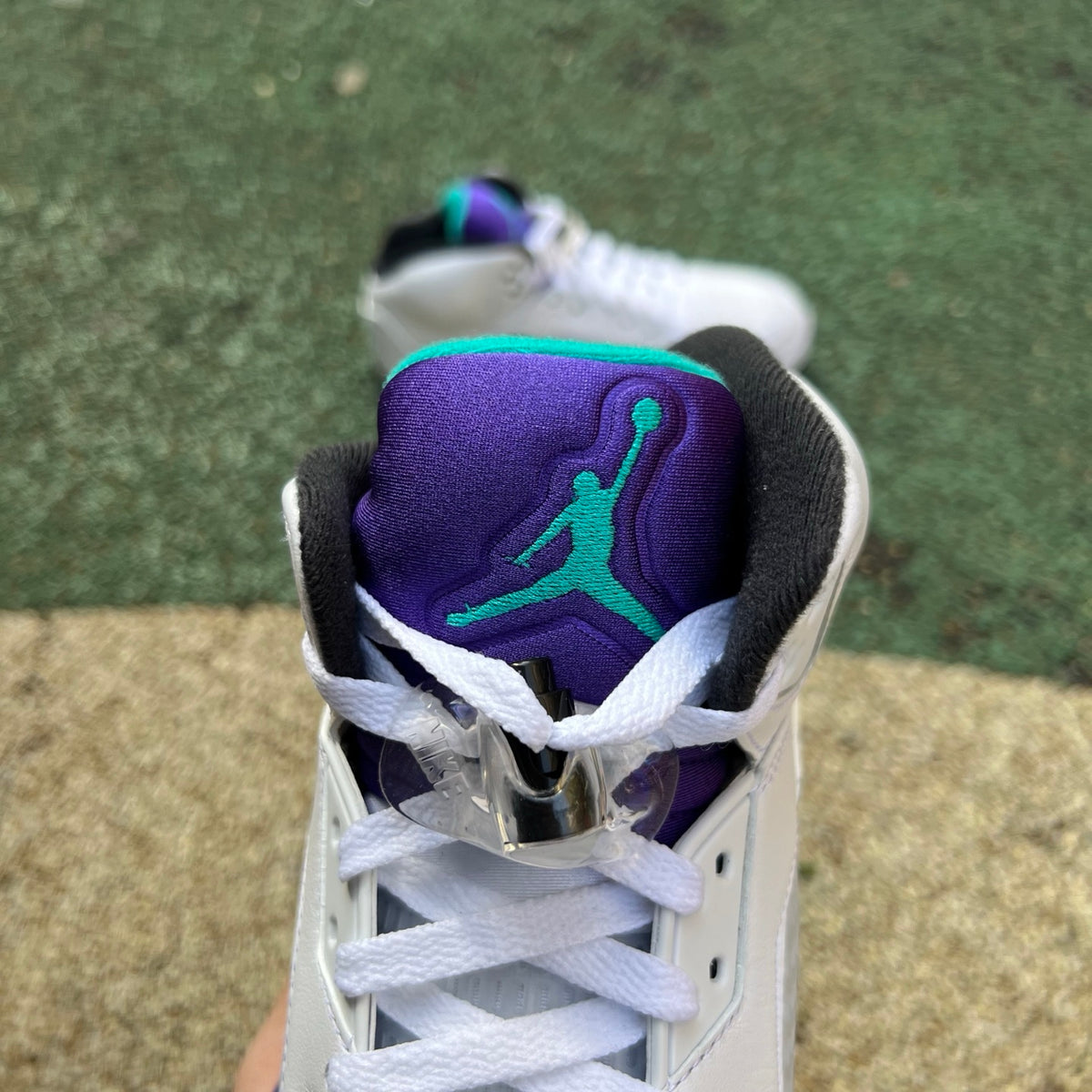 Nike Air Jordan 5 Retro Grape sneakers in white, purple, and black with a detailed close-up of the shoe's design and materials.