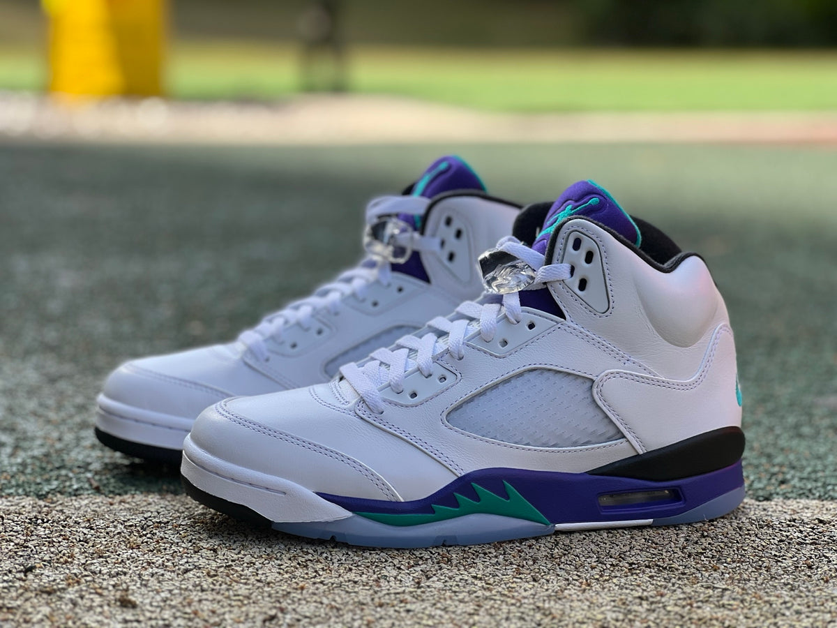 Nike Air Jordan 5 Retro Grape sneakers in white, purple, and teal with detailed close-up of the shoe's side and sole.