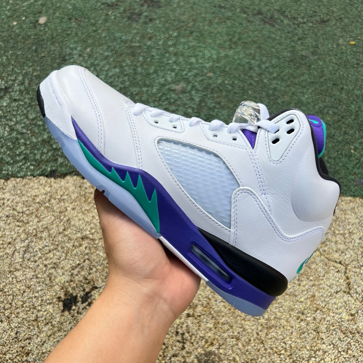 Nike Air Jordan 5 Retro Grape sneakers in white and purple with black accents, detailed close-up of the iconic design.