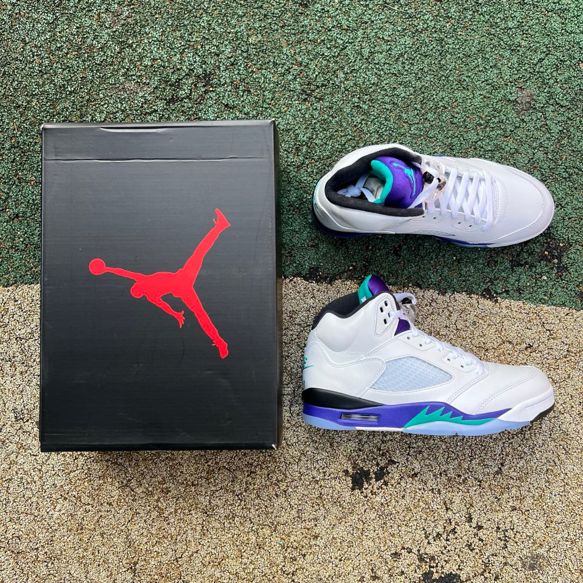 Nike Air Jordan 5 Retro Grape sneakers in white with purple and teal accents, featuring a detailed side view.