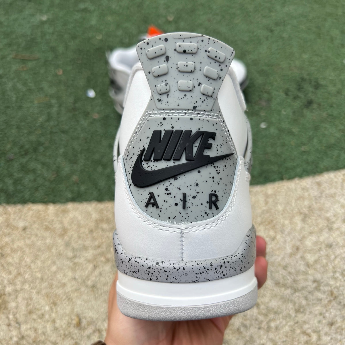 Nike Air Jordan 4 Retro White Cement sneakers from Nike x Jordan featuring white leather and cement grey accents.