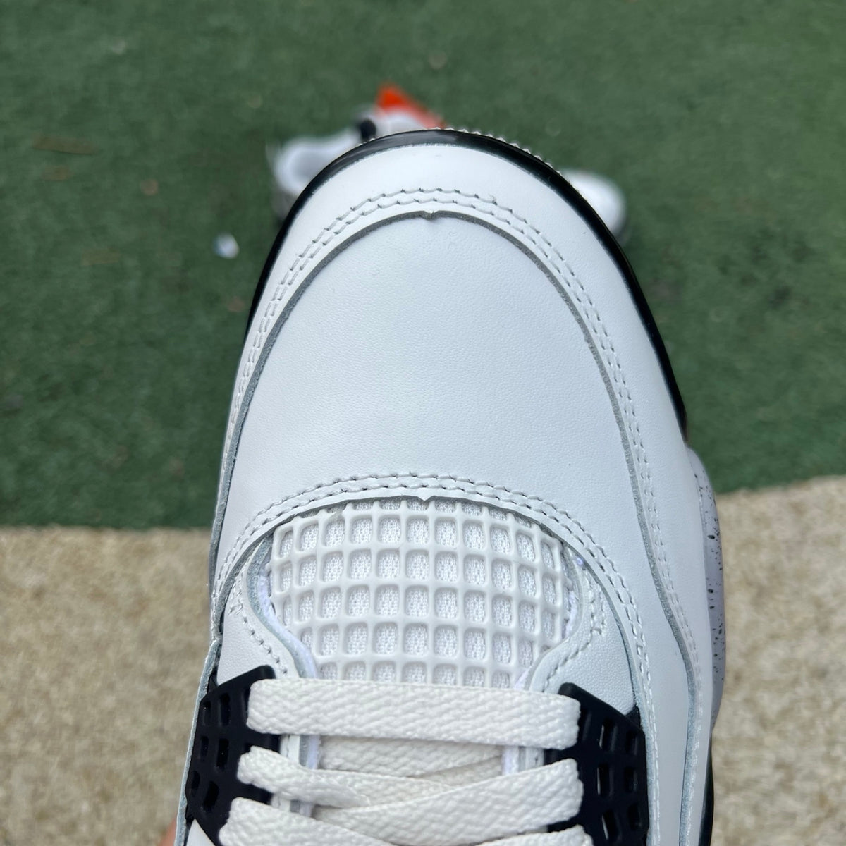 Nike Air Jordan 4 Retro White Cement sneakers, white and gray colorway, showcasing classic design and premium material details.