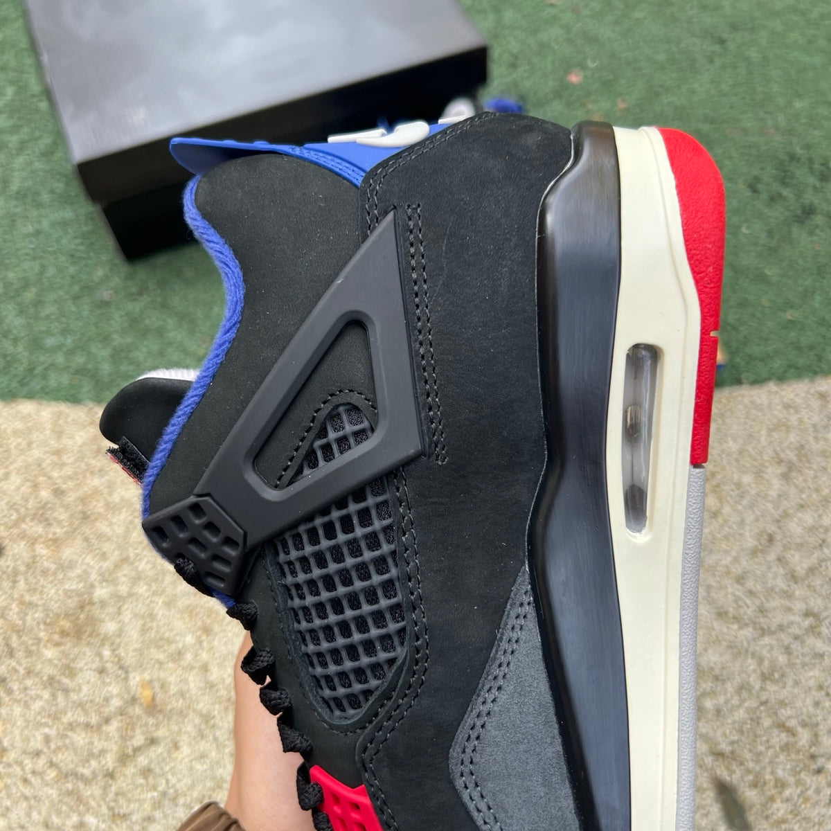 Nike Air Jordan 4 Retro Rare Air sneakers with white lettering, featuring a classic design and signature branding.