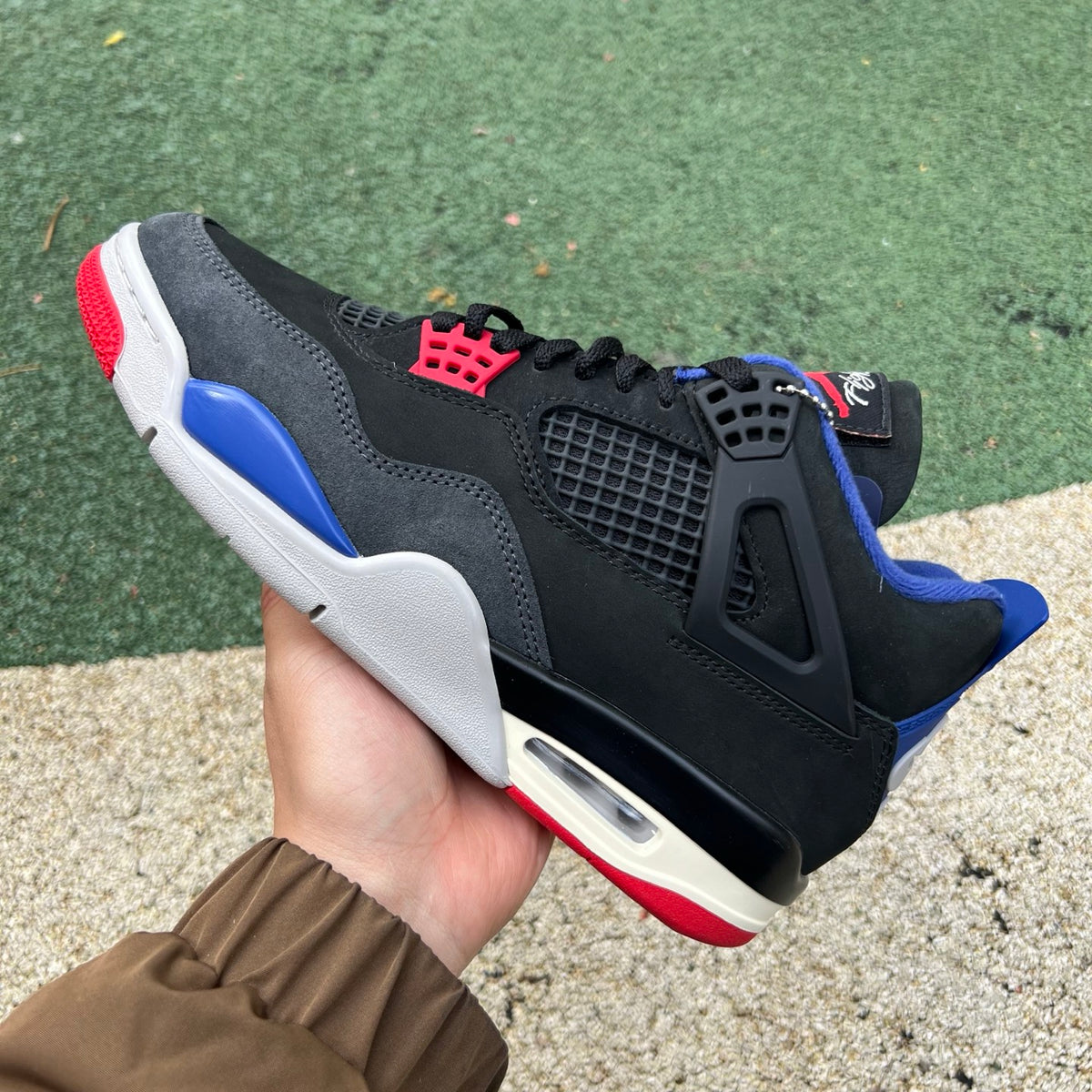 Nike Air Jordan 4 Retro Rare Air sneakers in white with distinctive lettering, featuring classic Nike x Jordan branding.