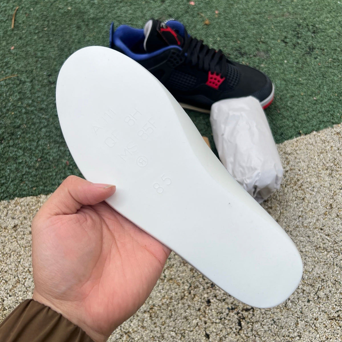 White Nike Air Jordan 4 Retro Rare Air sneakers with white lettering, featuring classic design details and Nike x Jordan branding.