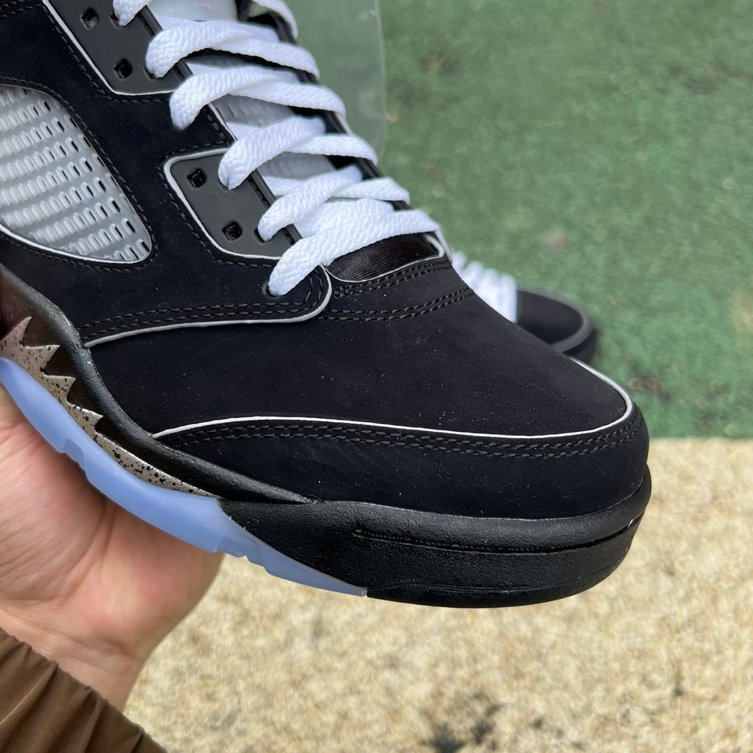 Nike Air Jordan 5 Retro OG sneakers in black with metallic accents, showcasing the reimagined design and iconic silhouette.