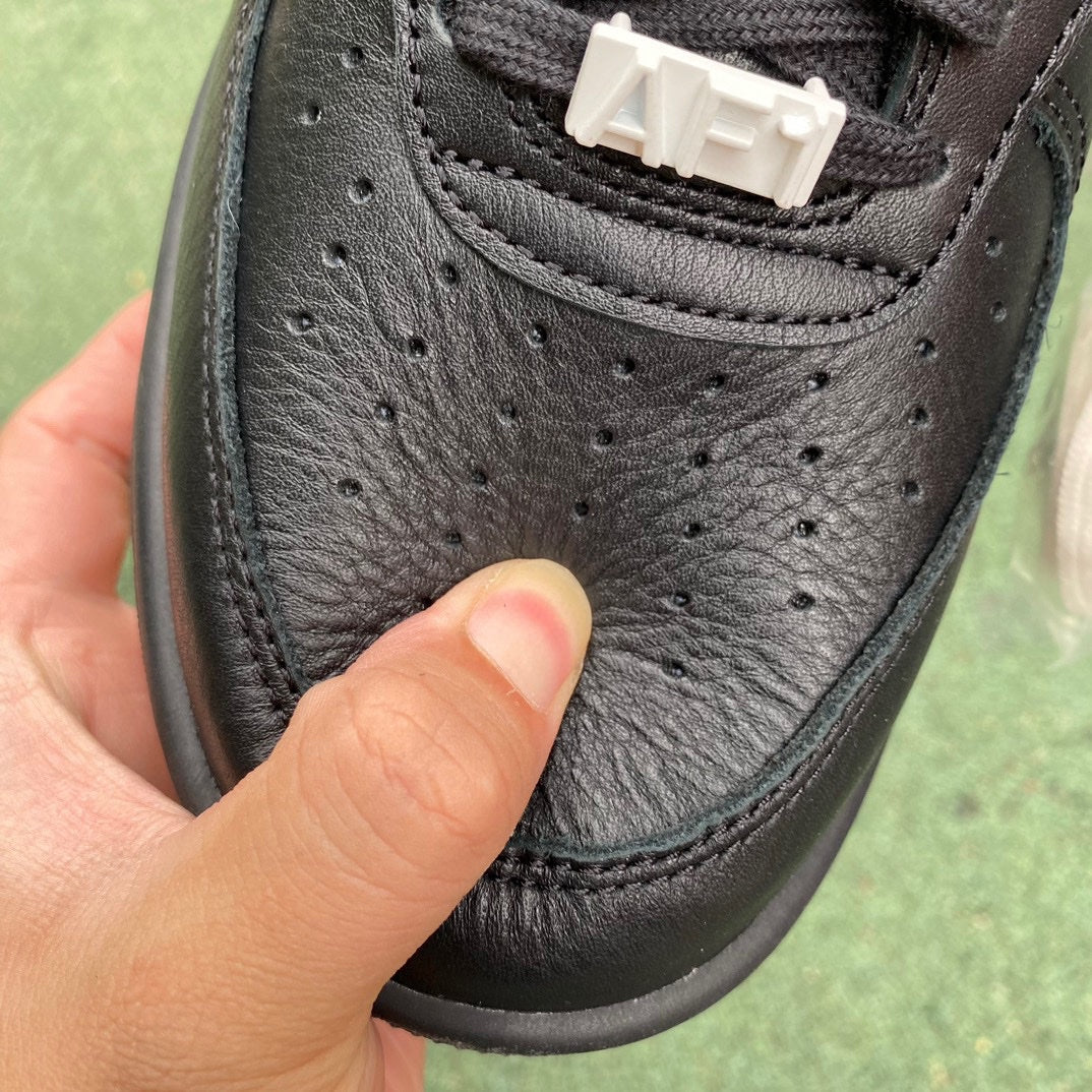 Nike Air Force 1 Low SP AMBUSH black sneakers featuring Nike x Jordan branding and stylish design details.