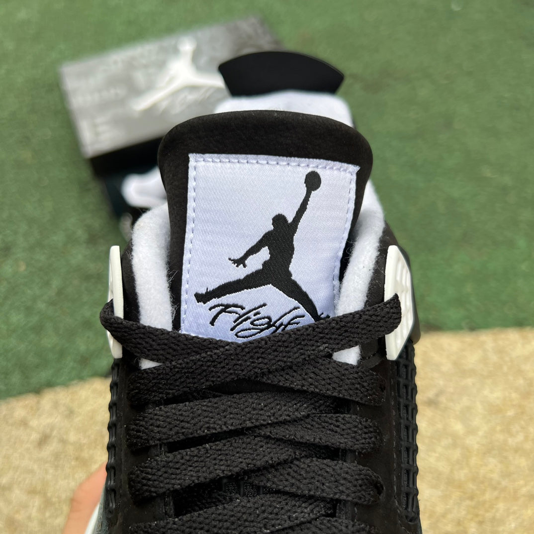 Nike Air Jordan 4 Retro Fear sneakers in black and purple with detailed design elements, shown from a side angle.