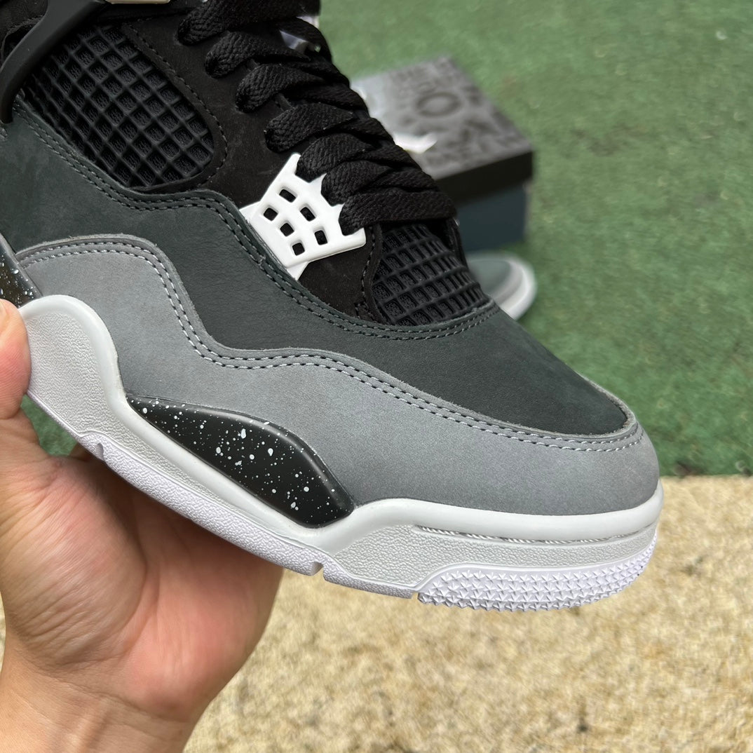 Nike Air Jordan 4 Retro Fear sneaker in black and red with detailed design and classic Jordan branding.