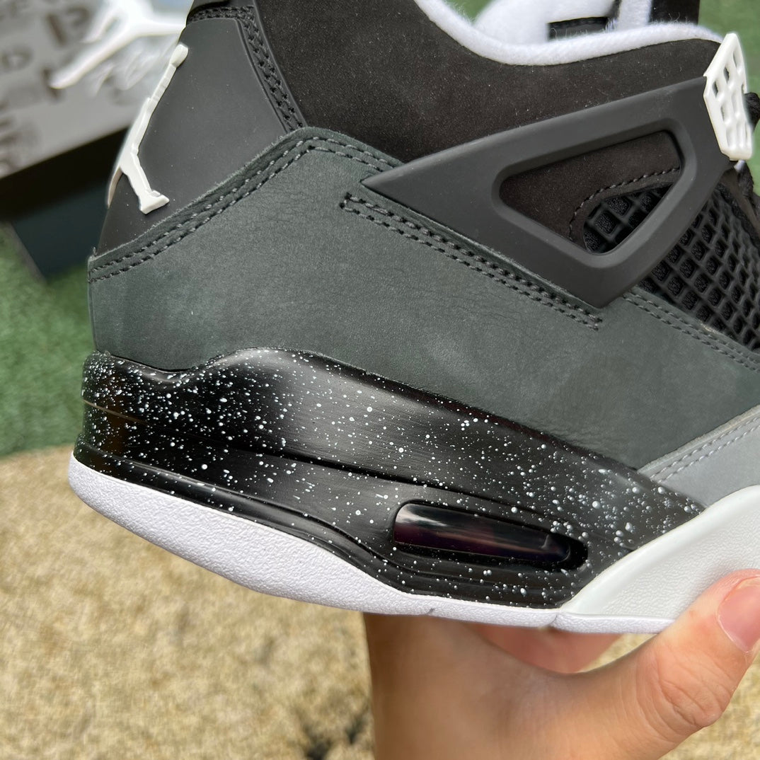 Nike Air Jordan 4 Retro Fear sneakers in black and purple, featuring classic design and Nike x Jordan branding.