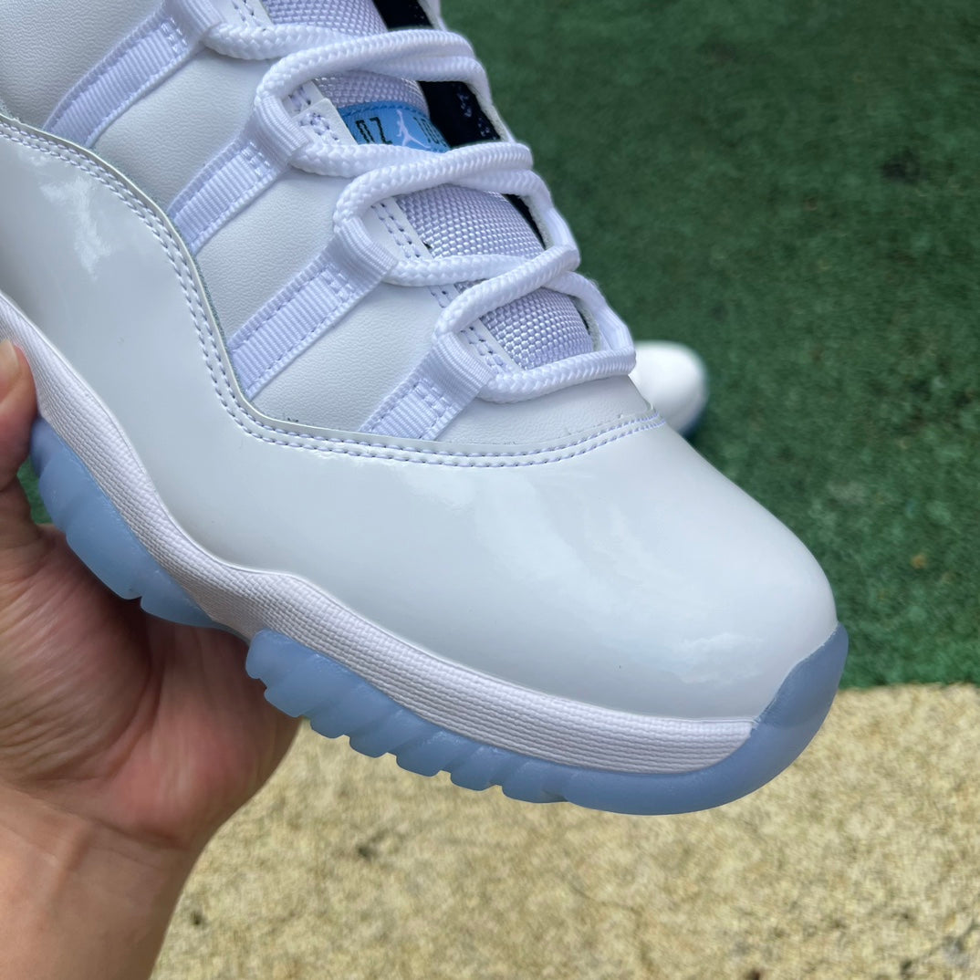 Nike Air Jordan 11 Retro Legend Blue sneakers in white and blue, featuring patent leather and iconic design details.