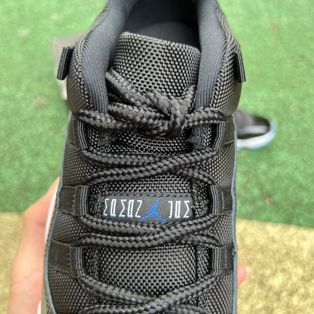 Nike Air Jordan 11 Retro Low Space Jam basketball shoes in black and white with patent leather accents.
